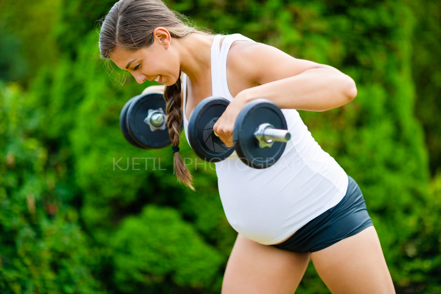 Determined Pregnant Woman Doing Back Workout With Dumbbells In P