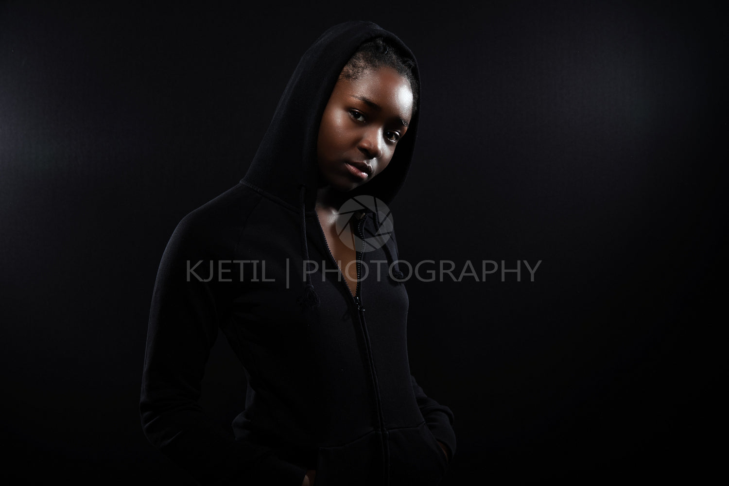 Cool and Beautiful Black Female Model Looking Into Camera on Black Background