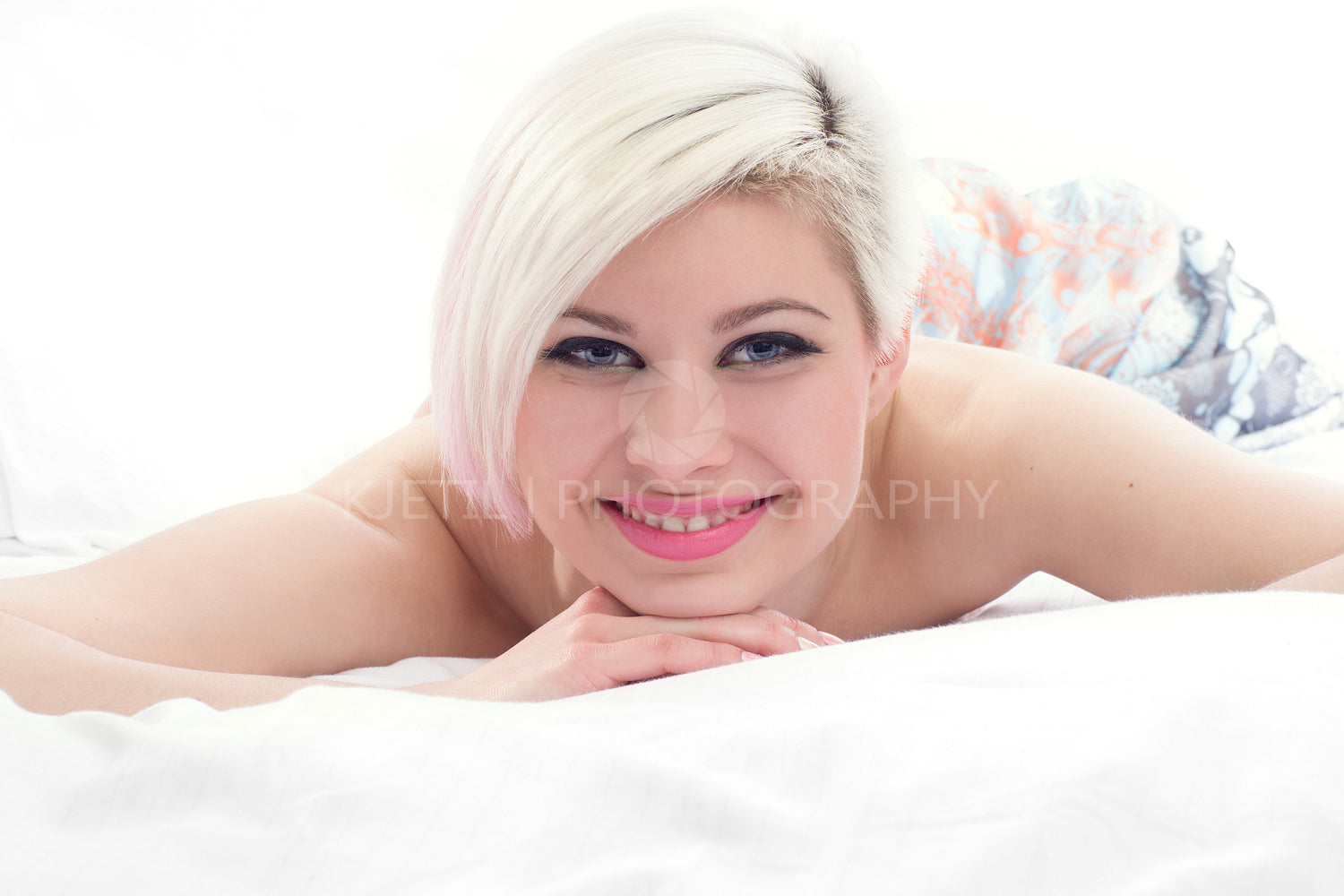 Smiling Young Woman in Bed