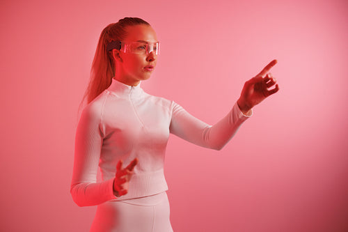 Woman in smartglasses against red neon background