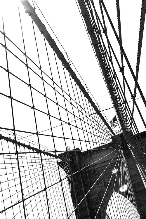 Details of the brooklyn bridge and the sun in black and white