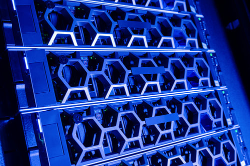 Closeup Of Modern Hard Drives In Illuminated Blue Datacenter