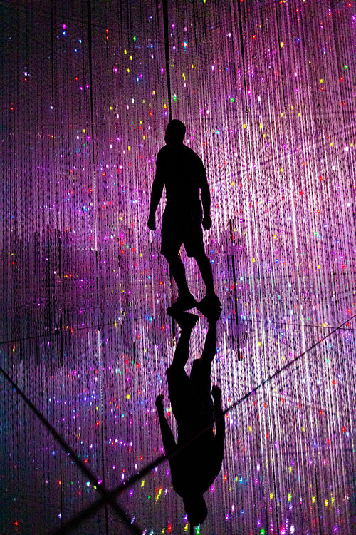 Man and other people in illuminated virtual multiverse concept