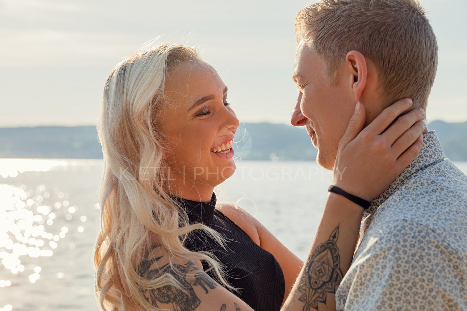 Happy Young Blond Woman Looking At Boyfriend