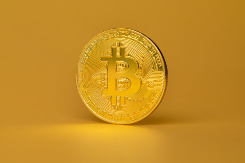 Bitcoin Crypto Currency Coin Standing On Golden Background