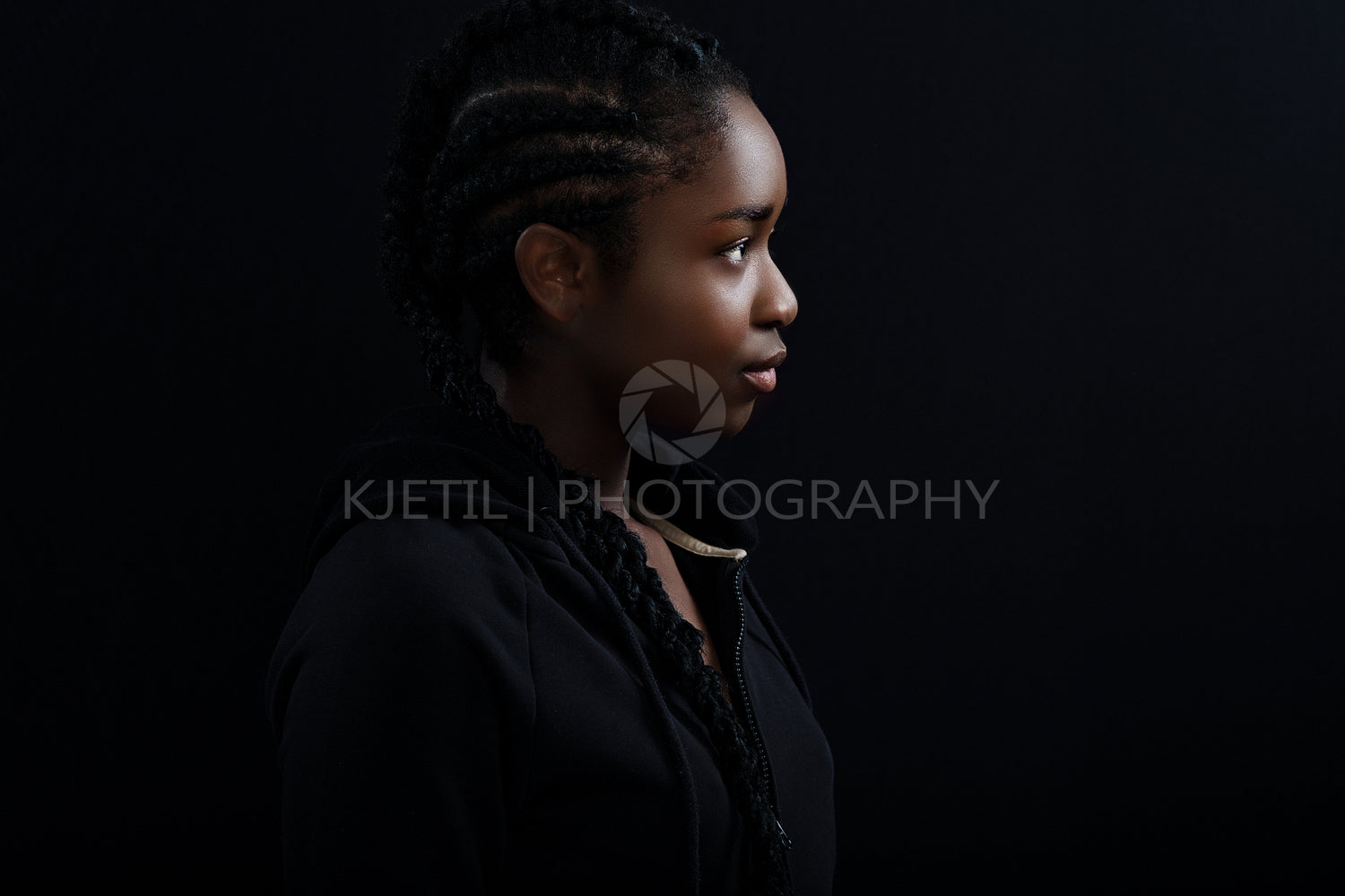 Cool and Beautiful Black Female Model Looking Away Against Black Background