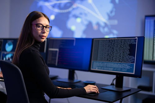 Female IT Consultant in cyber security team working to prevent security threats, find vulnerability and solve incidents