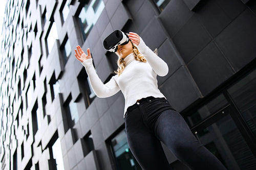 Woman Wearing Virtual Reality Glasses In City