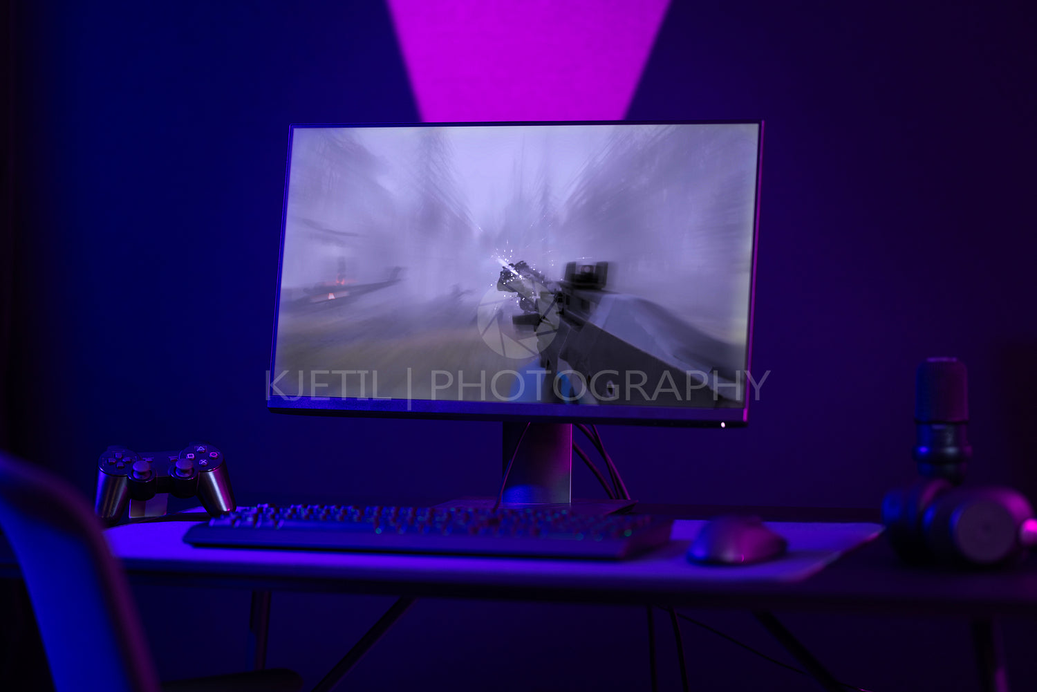 Colorful e-sport gaming and streaming studio with first-person shooter online video game on computer monitor