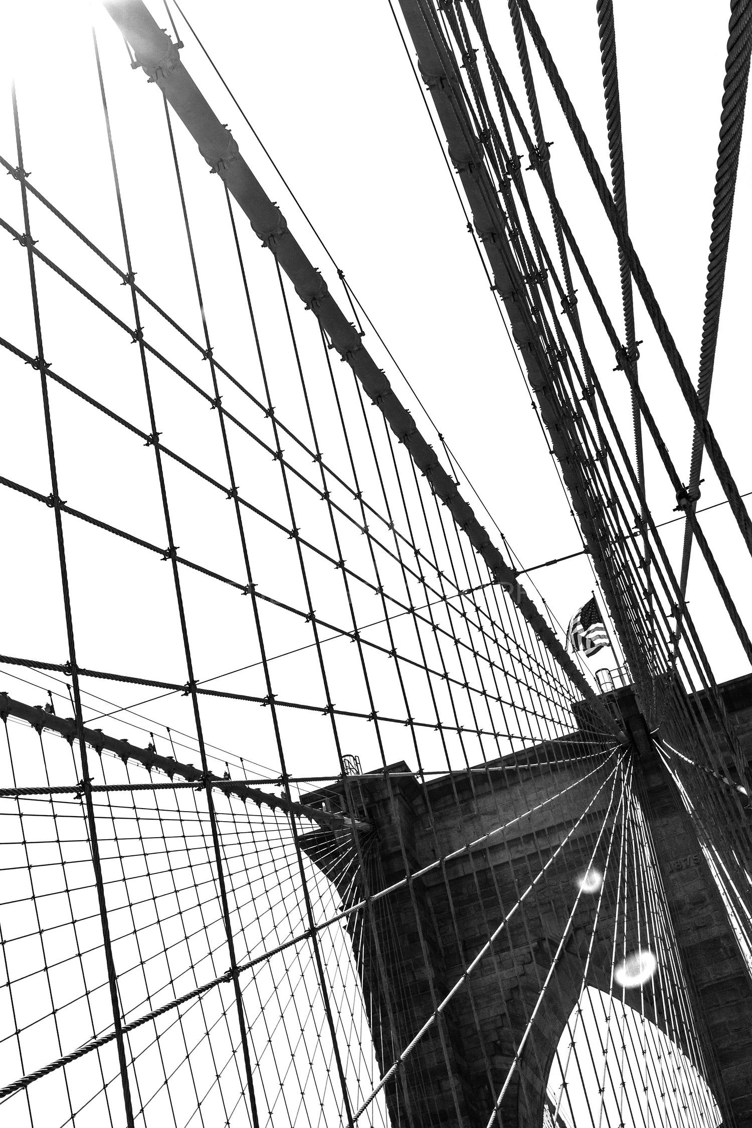 Details of the brooklyn bridge and the sun in black and white