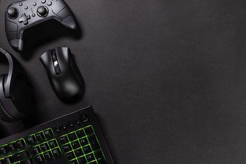 Gaming gadgets with green lit keyboard