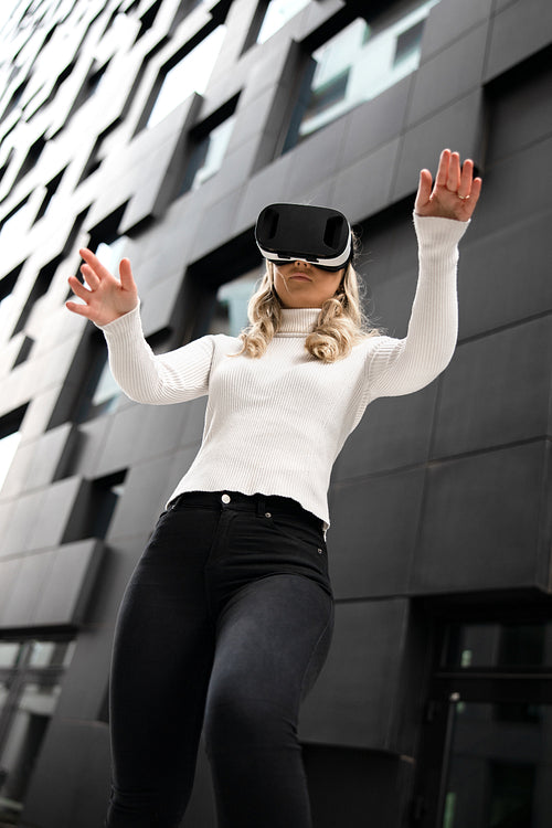 Woman Gesturing Using Virtual Reality Glasses In Metaverse Business
