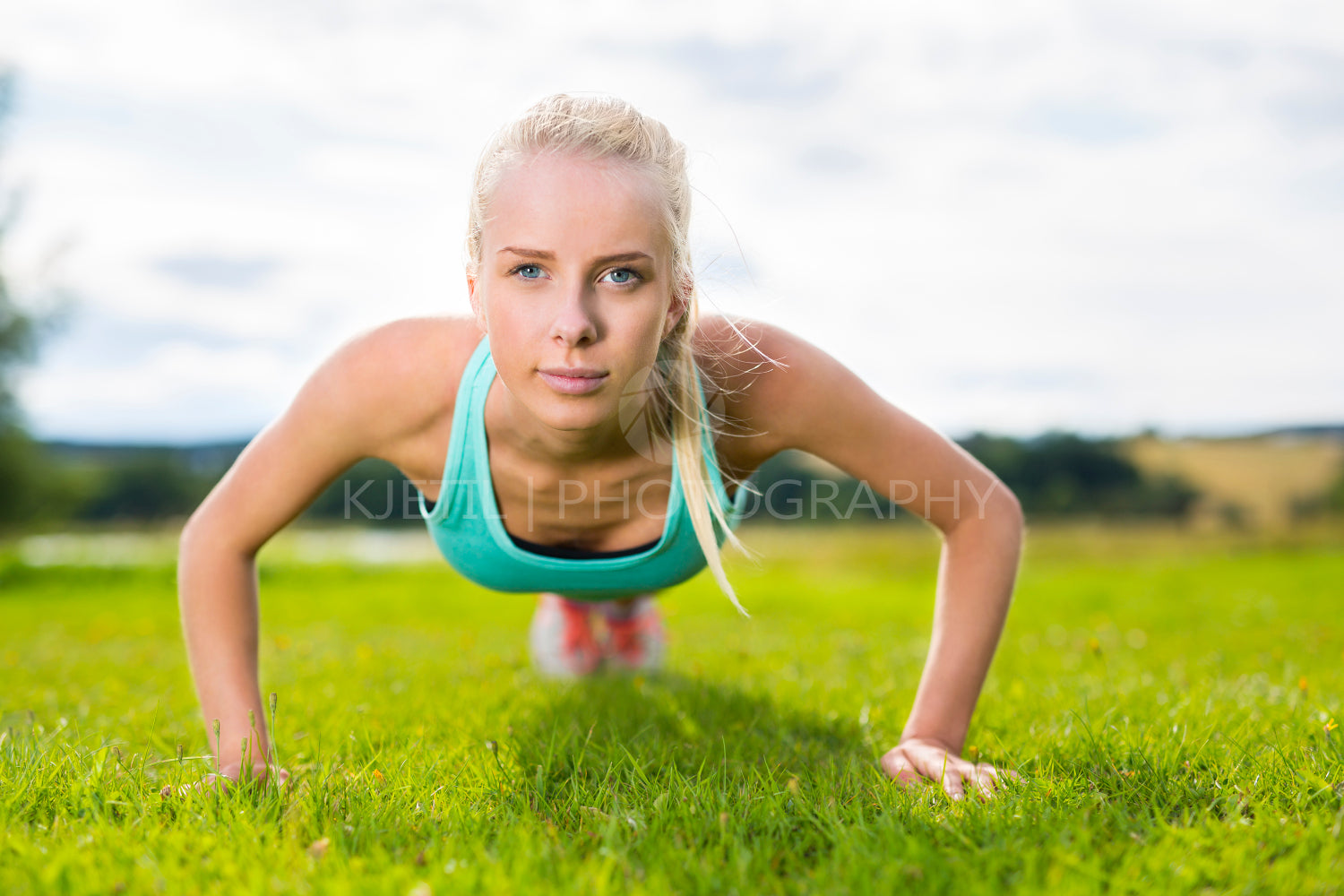 Blonde woman doing push-ups in the park