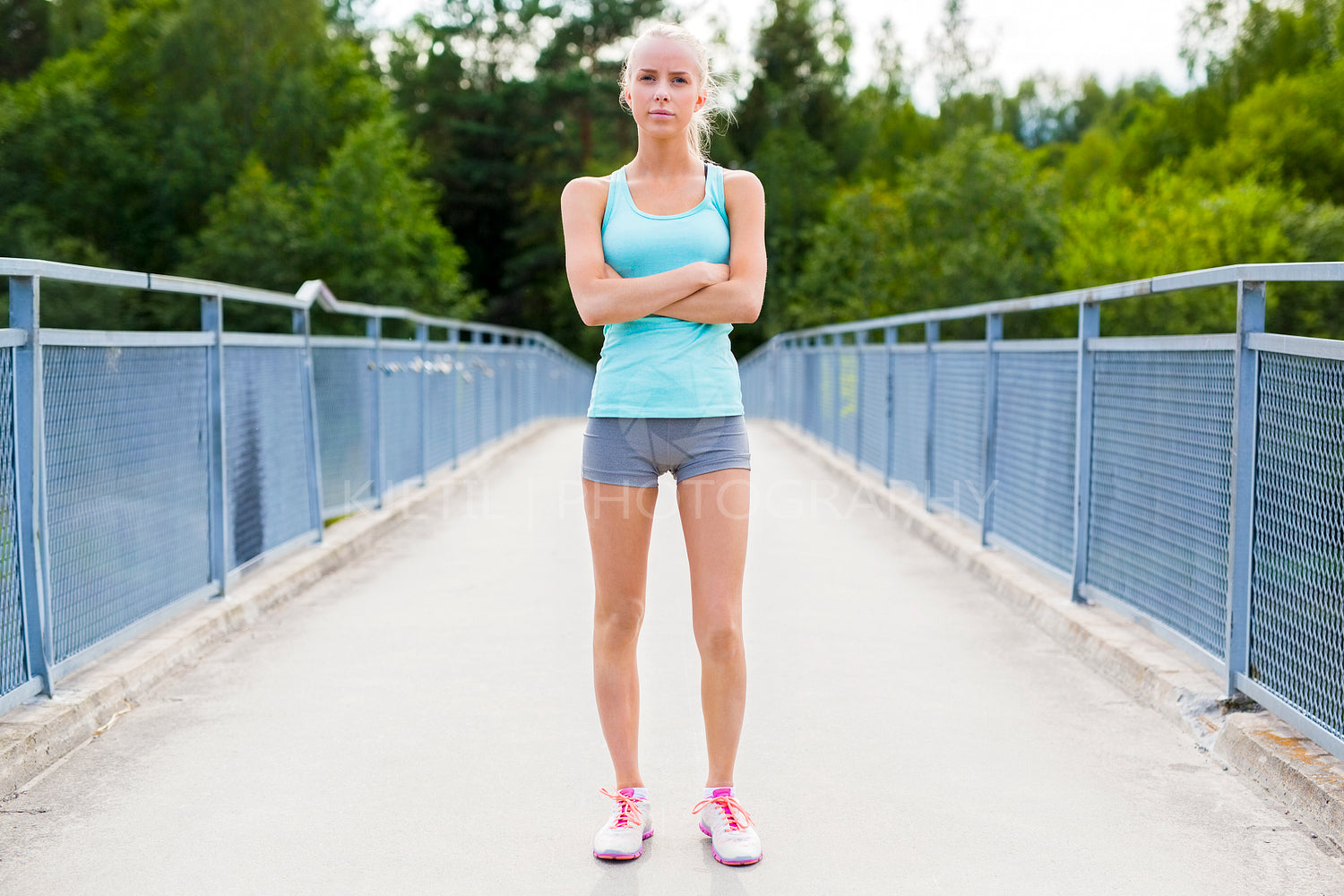 Confident young female runner having break after workout
