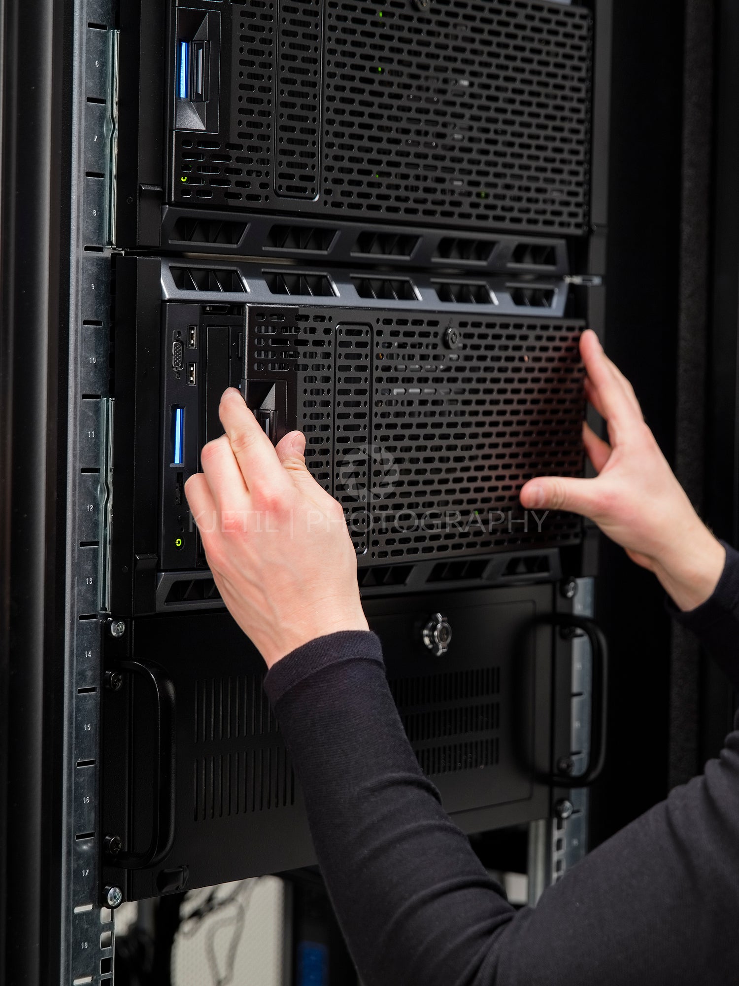 Colse-up of a IT consultant installing server in datacenter