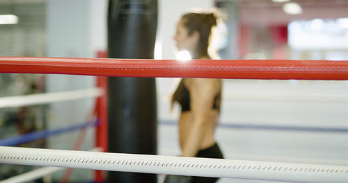 Beautiful woman tired after workout in boxing ring