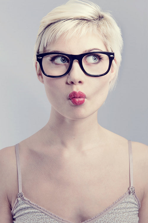 Cute woman with glasses in studio