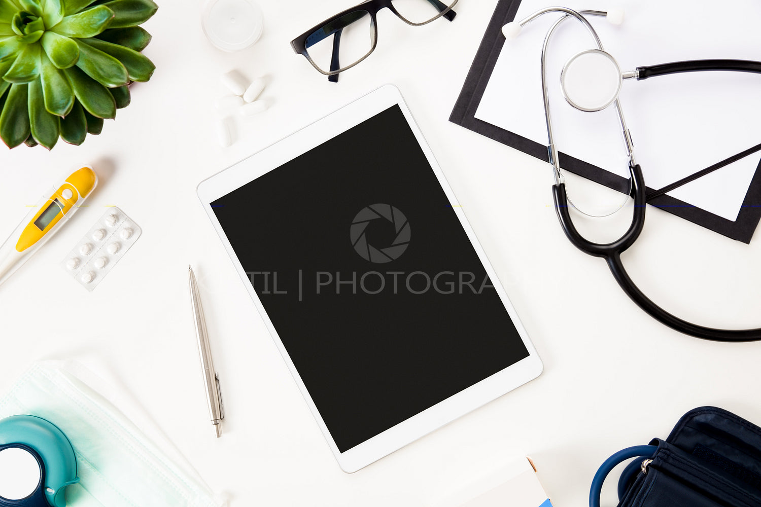 Digital Tablet With Pen And Medical Instruments On White Table