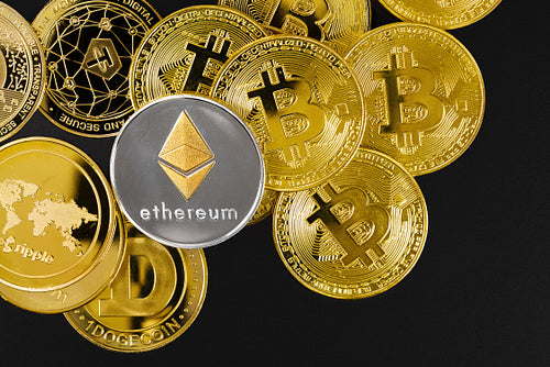 Ethereum coin on top of various golden cryptocurrencies