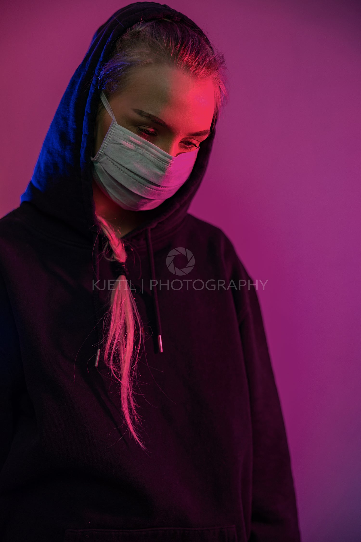 Exhausted or depressed woman in protective face mask with multi colored lights