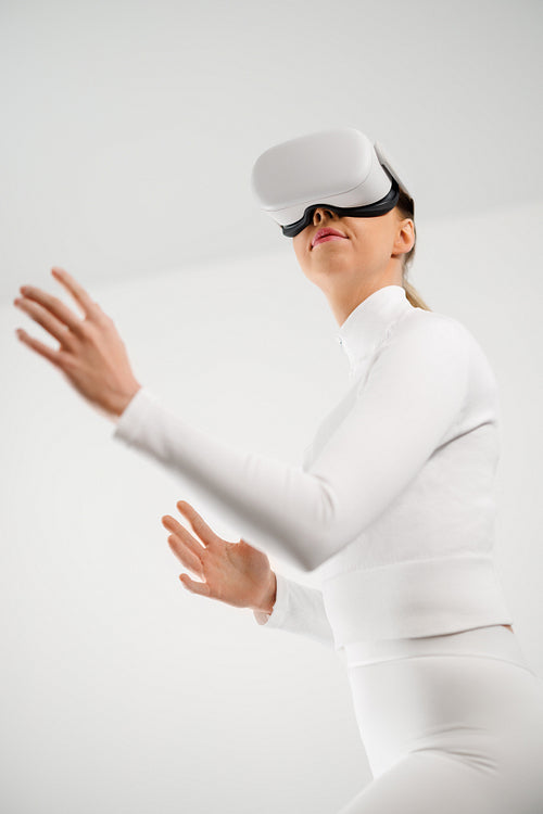 Young Woman Using Virtual Reality Headset in Minimal Setting