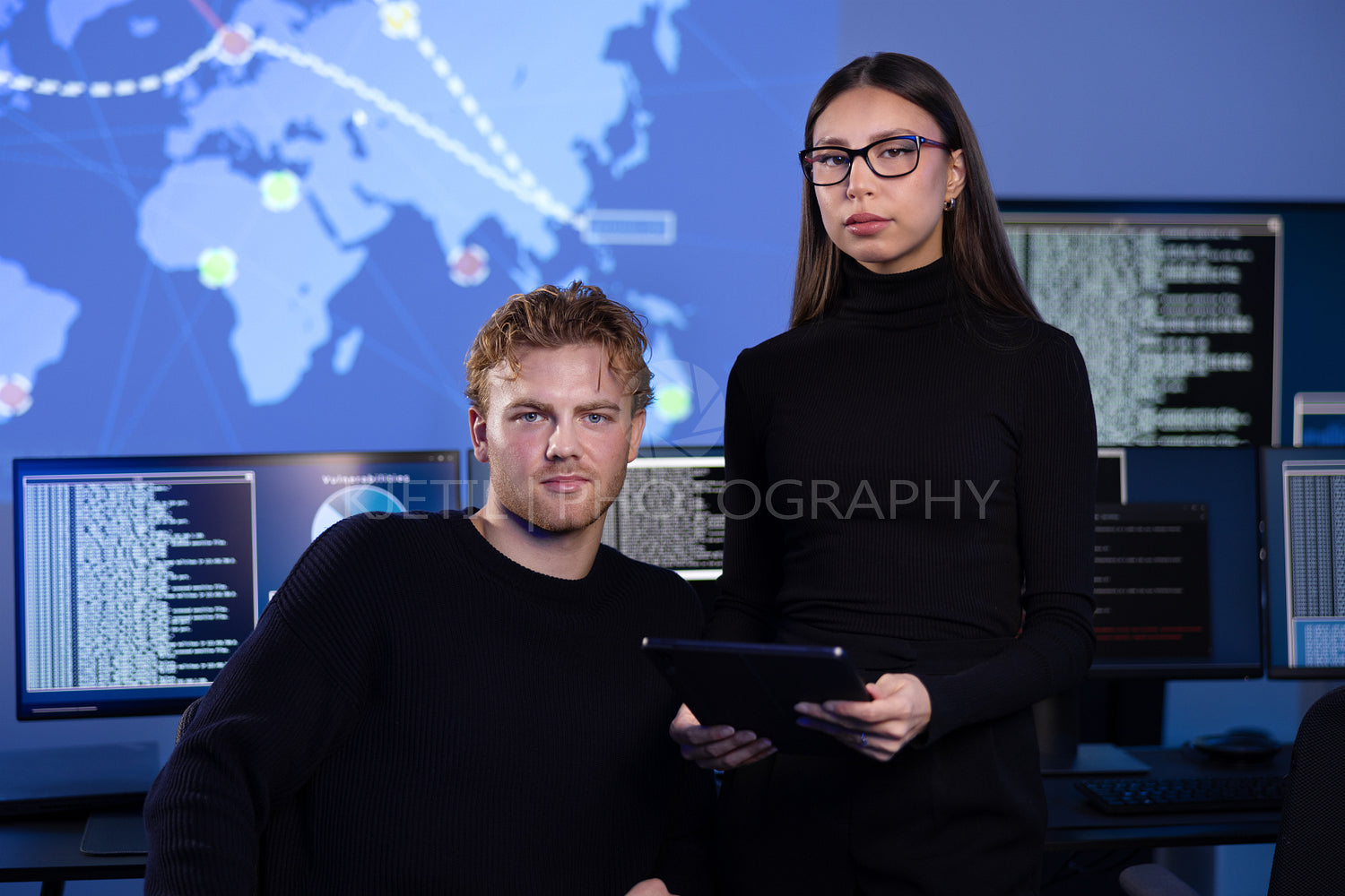 Professional serious cyber security team in front of cybersecurity SIEM system with logs and incident map