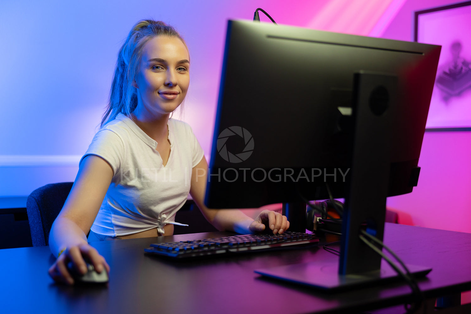 Happy and tired Beautiful Blonde Gamer Girl Playing Online Video Game on Her Personal Computer.