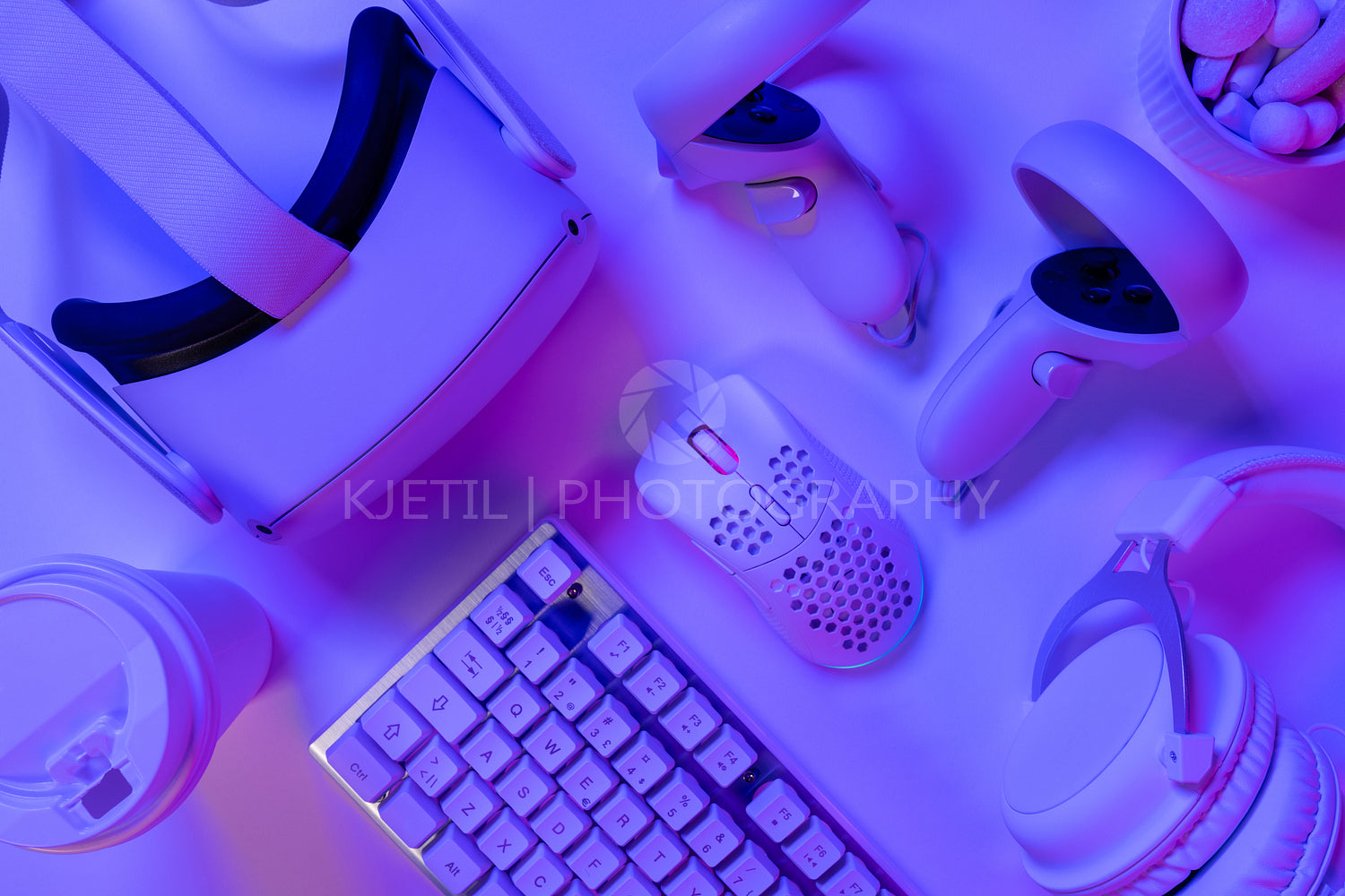 Various modern gaming accessories on purple desk