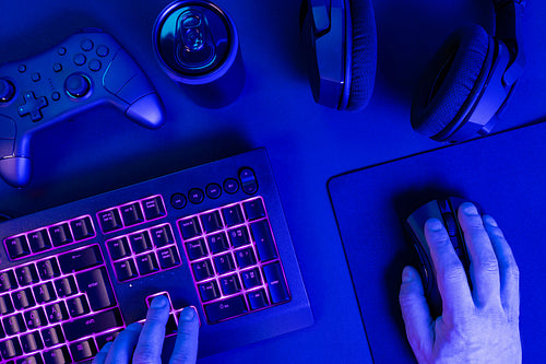 Hands using keyboard with mouse while gaming