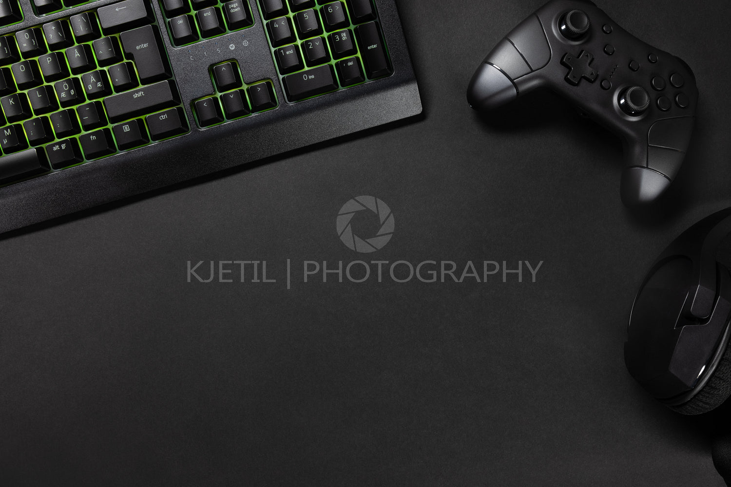 Green lit keyboard by game controller and mouse