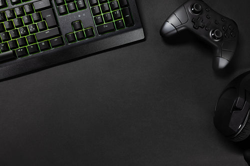 Green lit keyboard by game controller and mouse