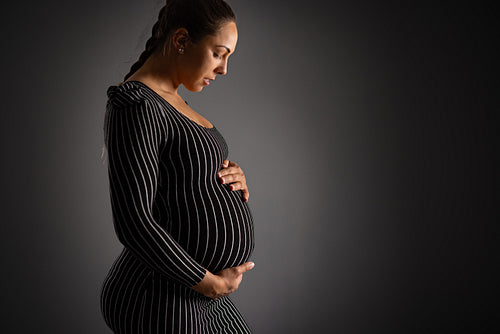 Elegant Pregnant Woman Embracing Her Belly Gracefully