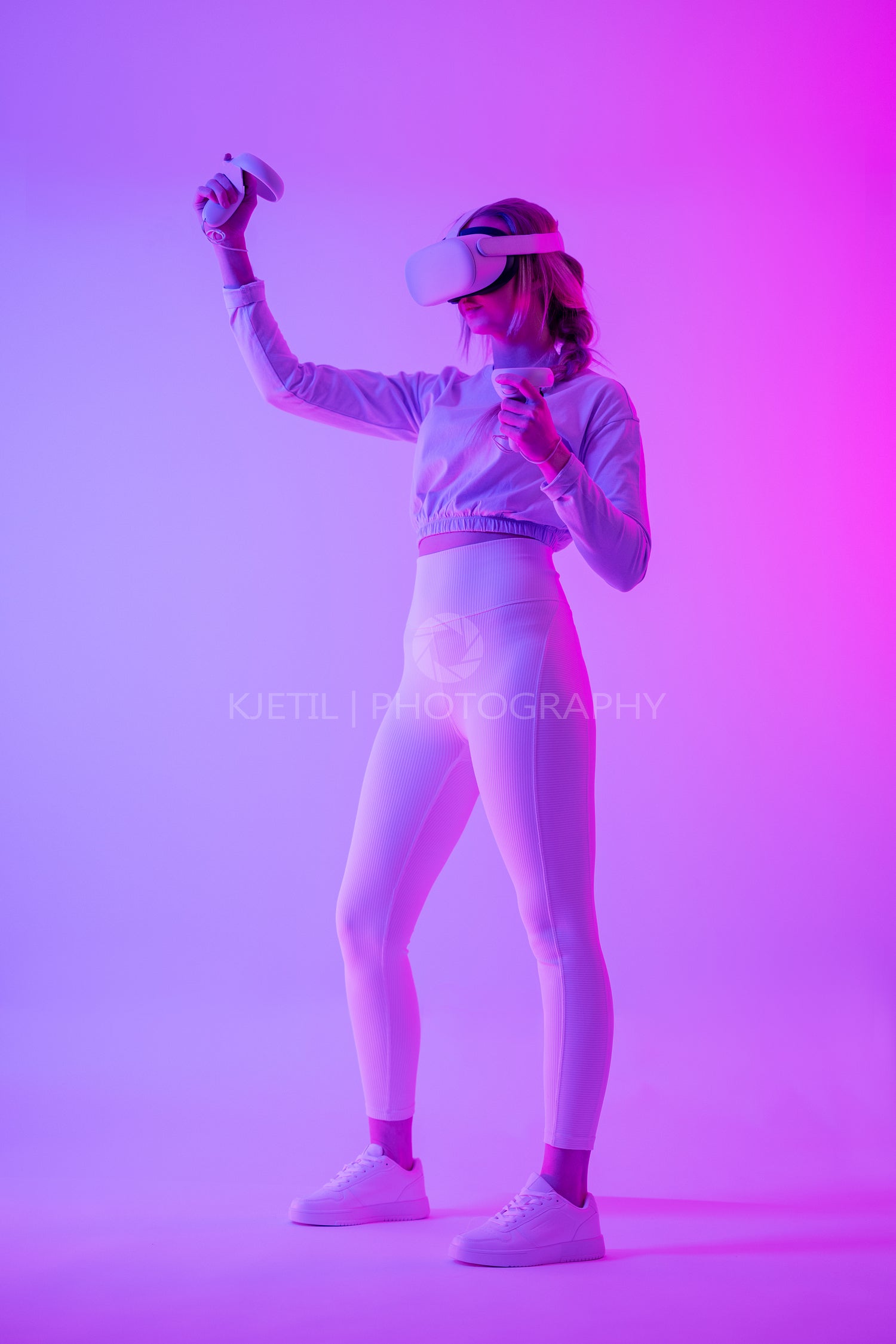 Woman immersed in virtual reality with headset and controllers in neon lights