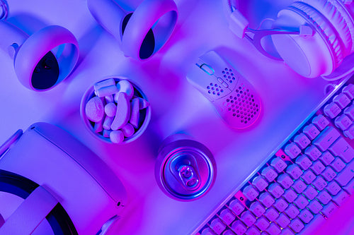 Gadgets and marshmallows with drink can on desk