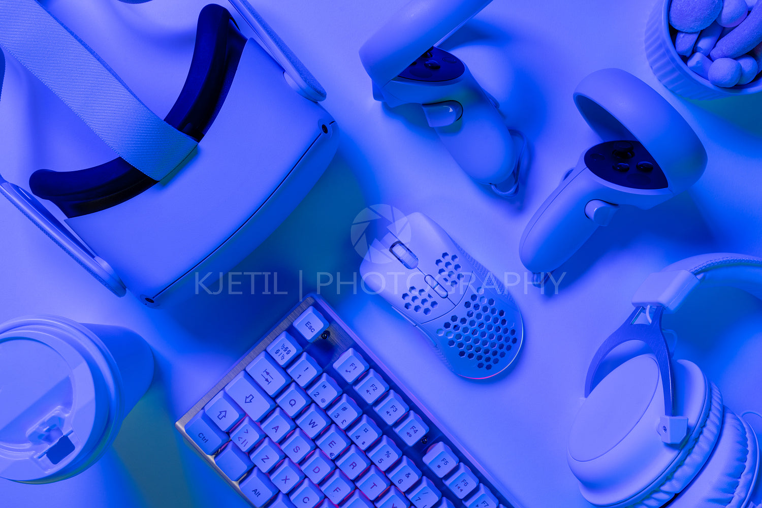 Various gaming accessories on blue desk