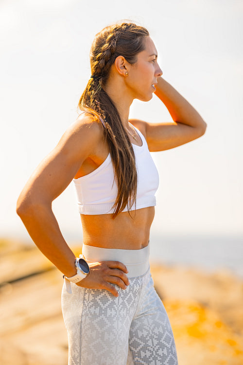 Fit Woman Wearing Fitness Tracker During Outdoor Workout