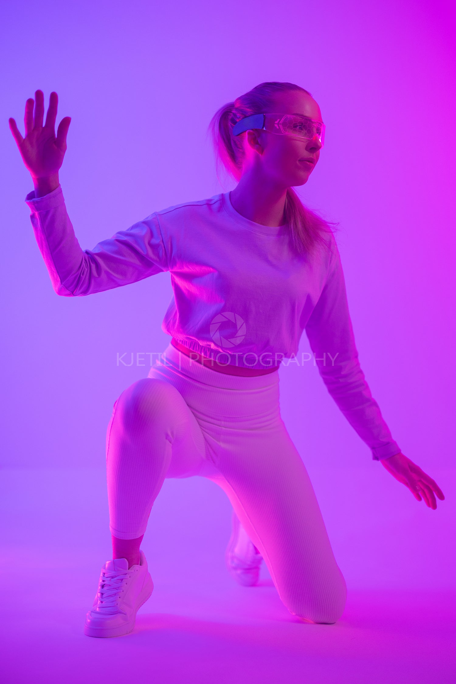 Woman interacting with virtual reality in vibrant neon colored lighting