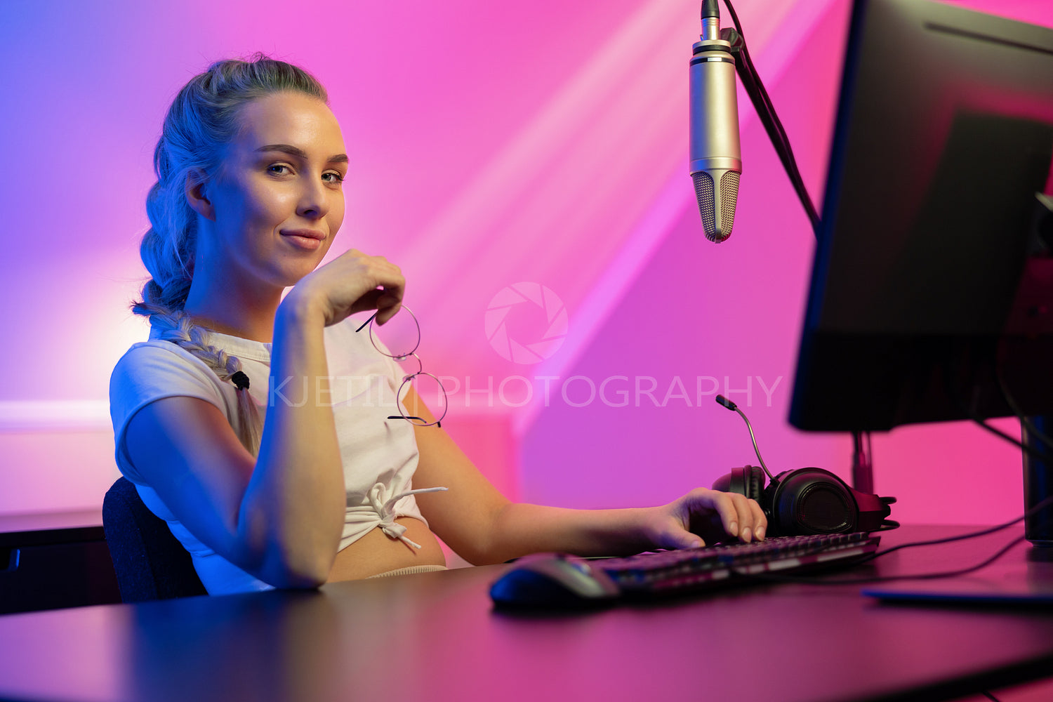 Professional gamer girl looking into camera and play online multiplayer video game on PC