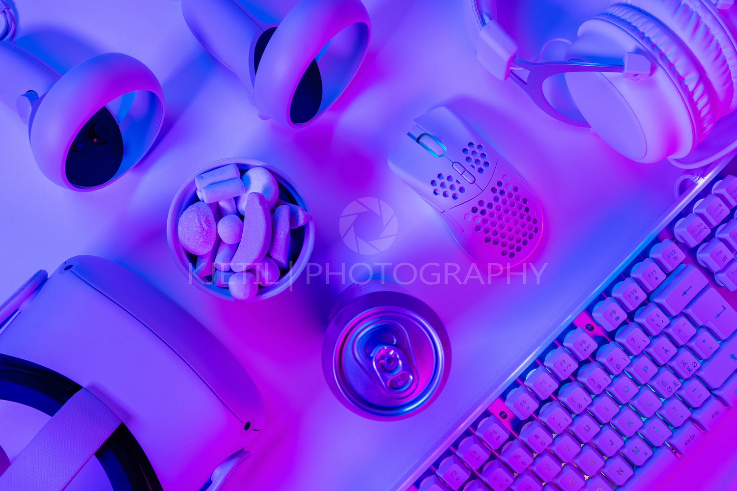 Gadgets and marshmallows with drink can on desk