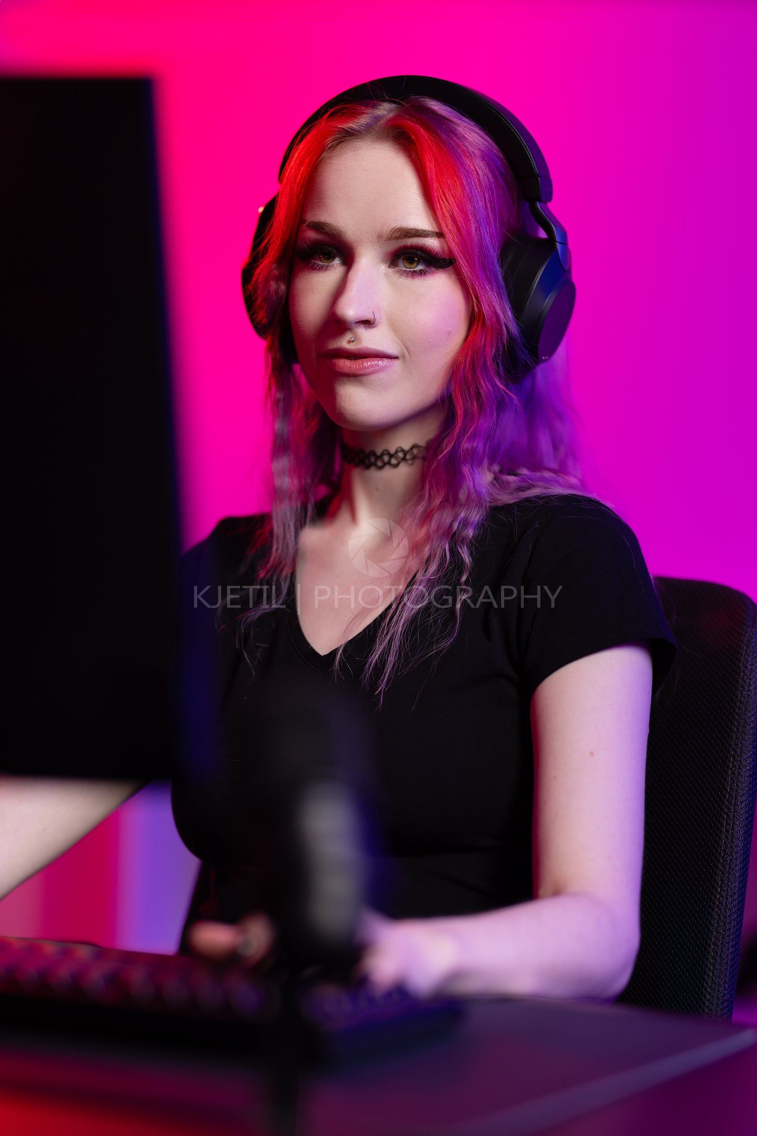 Focused Female Gamer Playing in Neon-Lit Room