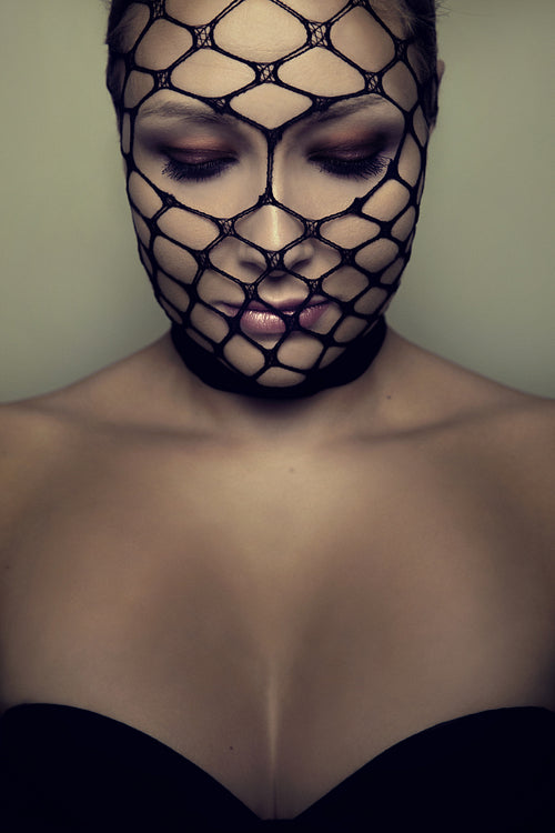Beautiful Blonde Woman With Closed Eyes and Black Mesh On Her Face
