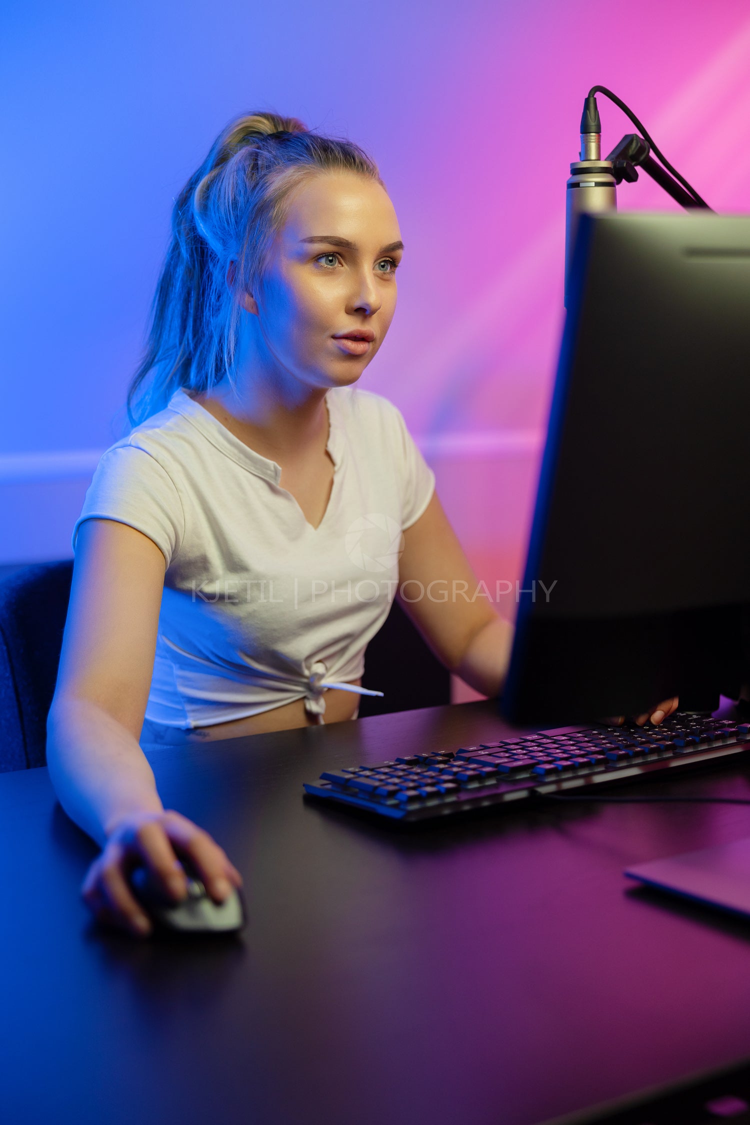 Close-up of focused professional gamer girl playing online multiplayer video game on PC