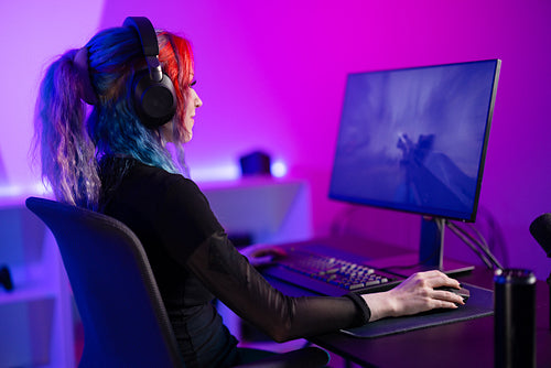 Focused Gamer Playing first-person shooter in a Vibrant, Colorful Room