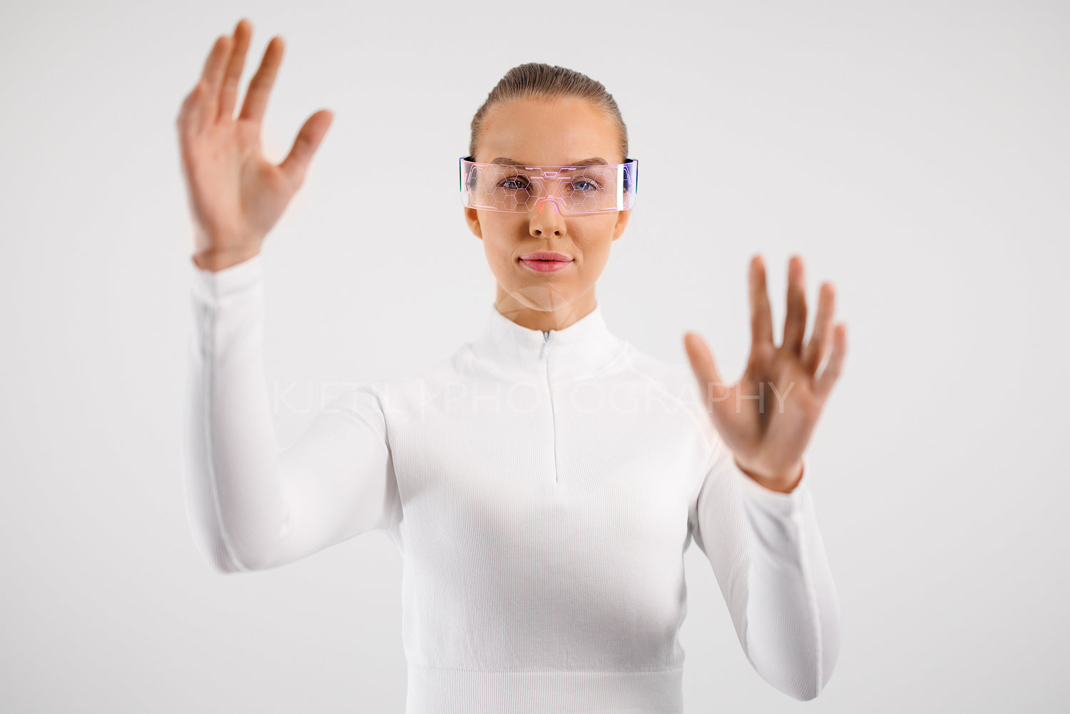 Young Woman in White Using Virtual Interface Technology