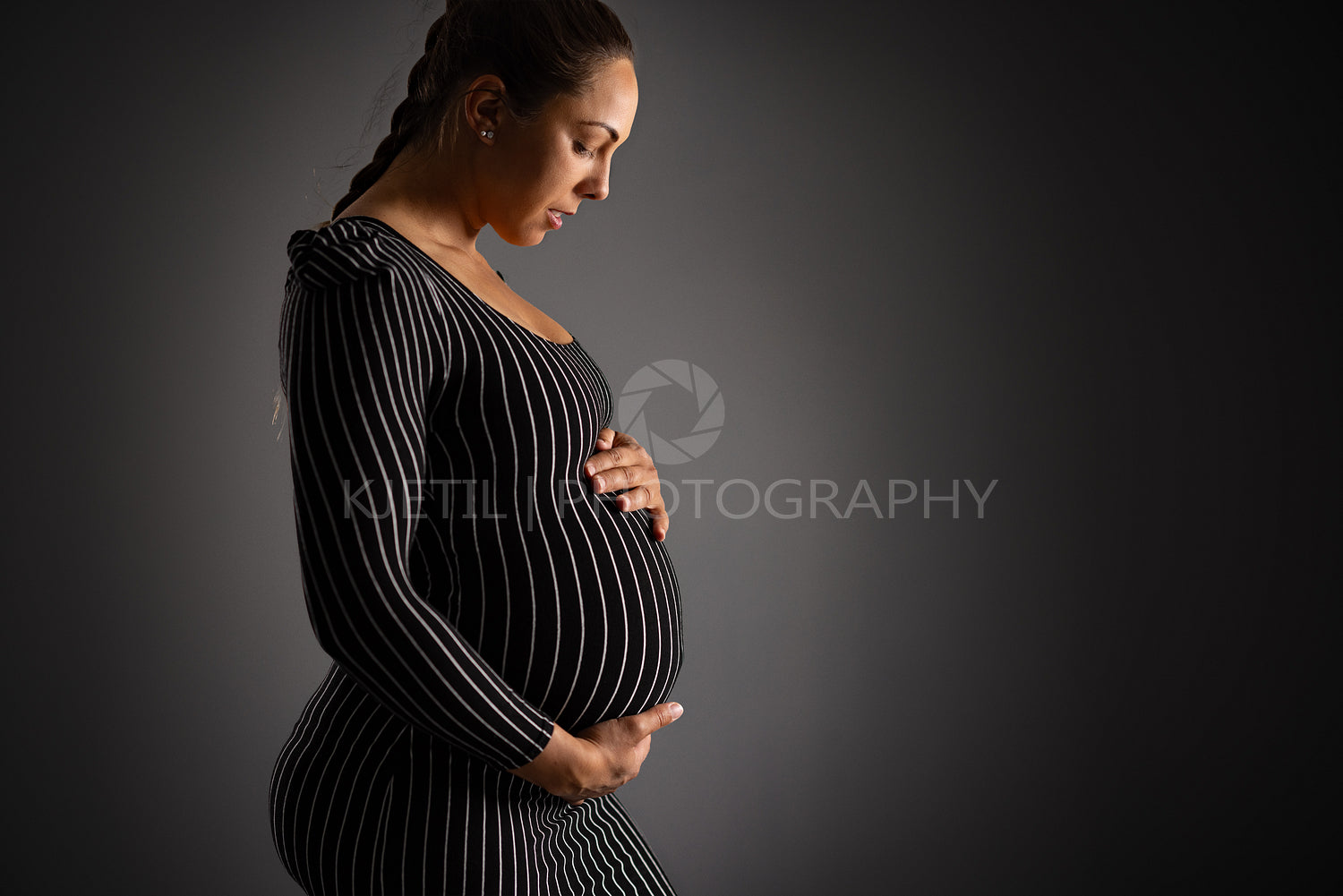 Elegant Pregnant Woman Embracing Her Belly Gracefully