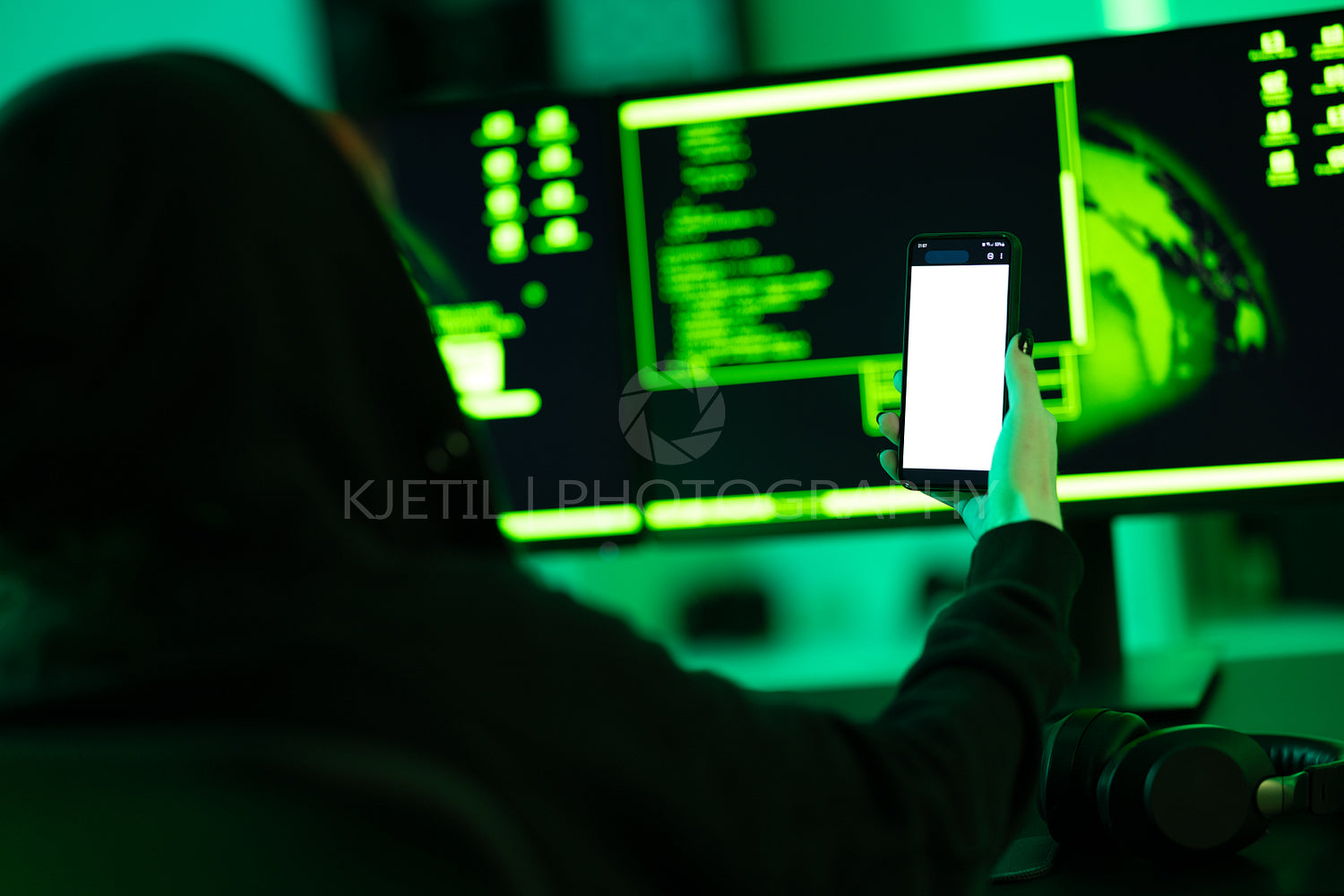 Hacker using smartphone in dimly lit cyber security environment