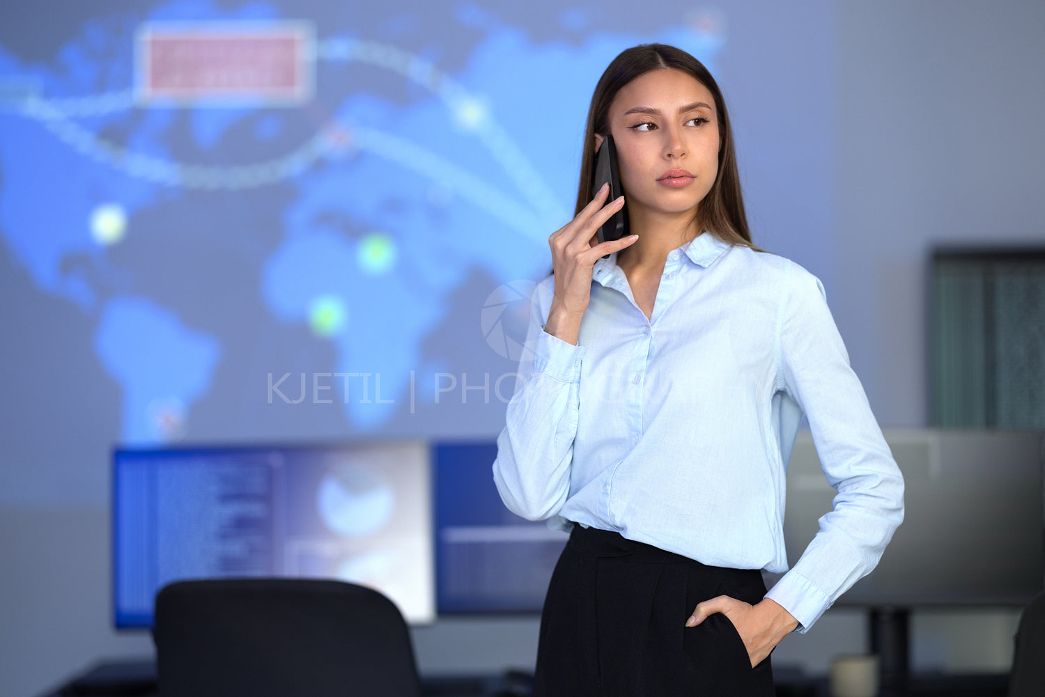 Focused Female Cybersecurity Manager talking in the phone in Enterprise Cyber Security Operations Center SOC