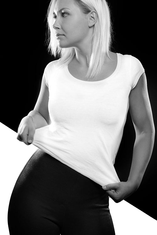 Black and white split portrait of woman standing in studio