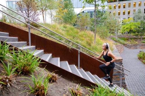 Fit sports women running interval workout in stairs in city park