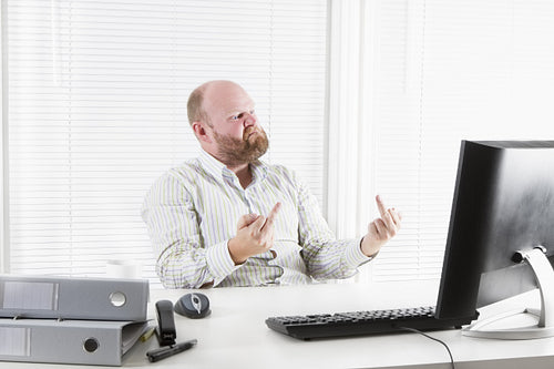 Angry Businessman Gives Finger to his Computer